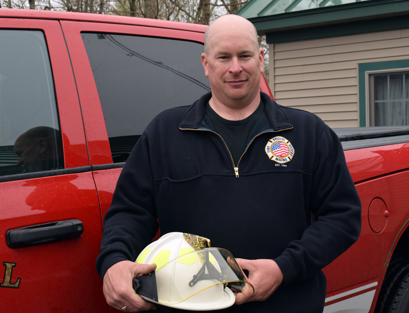 Bristol Fire Chief Scott Sutter Jr. holds the chief's helmet by the chief's truck on Thursday, April 29. Sutter became the town's second full-time fire chief effective Saturday, May 1. (Evan Houk photo)