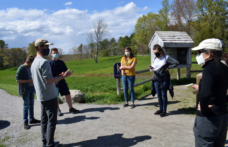 Pearce Kelley, of the Maine Mathematics and Science Alliance, left, discusses a mission on the STEMports augmented reality app with Great Salt Bay Community School students, his colleague Brittney Nickerson (second from right), and GSB enrichment specialist Alison Macmillan (right) at the Whaleback Shell Midden State Historic Site in Damariscotta on Wednesday, May 12. (Evan Houk photo)