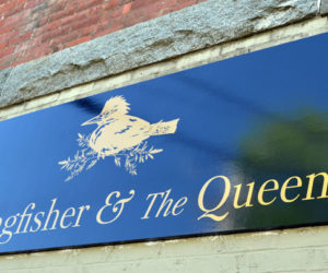 A sign advertises The Kingfisher and The Queen at 79 Main St. in downtown Damariscotta. The store opened Saturday, May 22. (Maia Zewert photo)