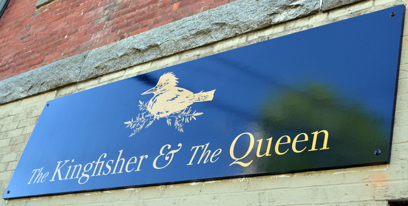 A sign advertises The Kingfisher and The Queen at 79 Main St. in downtown Damariscotta. The store opened Saturday, May 22. (Maia Zewert photo)