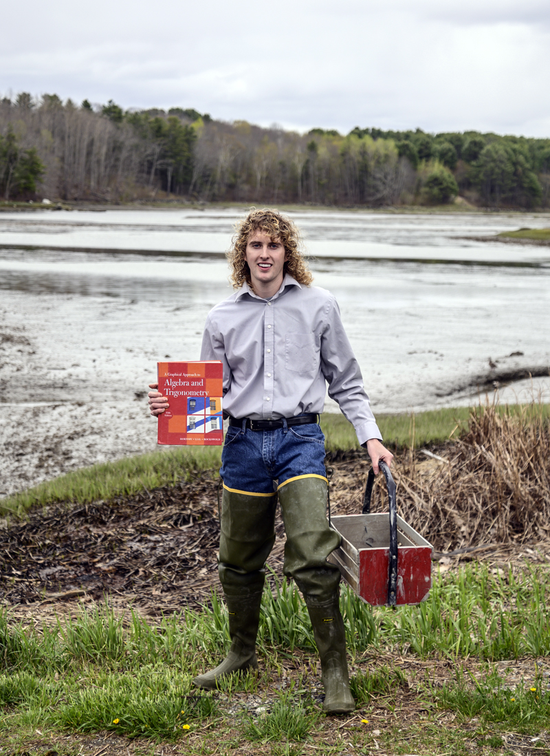 Zak Melvin showcases his two careers in Waldoboro on Saturday, May 8. Melvin wore hip-high waders to represent his clamming heritage and a blue button-down shirt to represent his full-time job as a math teacher at Medomak Valley High School. (Bisi Cameron Yee photo)