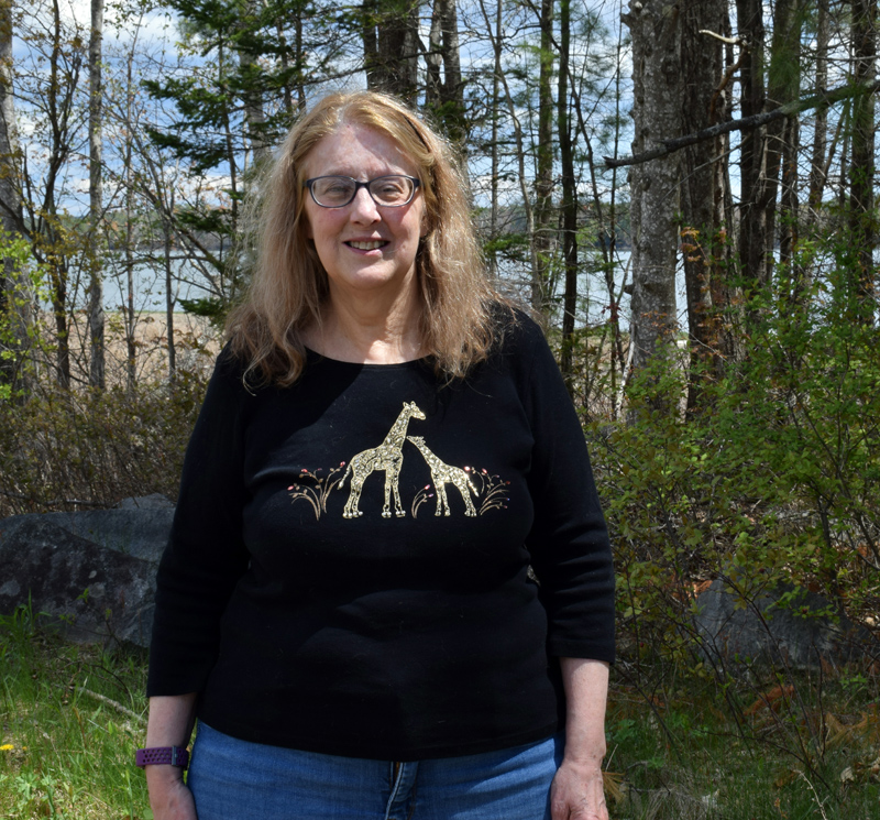Laurie McBurnie stands in front of Great Salt Bay on Monday, May 10. McBurnie has spent her life working with children and is actively involved in the Nobleboro Cemetery Committee and the Nobleboro Historical Society. (Evan Houk photo)