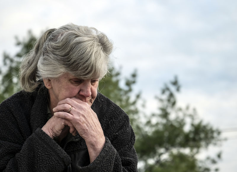 Viola Stone stands outside her camper home in Waldoboro on May 4. The camper does not have the minimum 750 square feet of living space the town requires. (Bisi Cameron Yee photo)