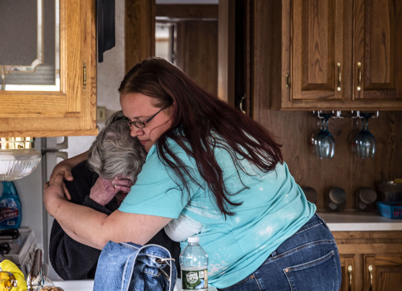 Rachel Lane hugs mother-in-law Viola Stone as Stone is overcome by emotion in Waldoboro on May 4. Stone lost her home, pets, and all her possessions in a fire last November. (Bisi Cameron Yee photo)