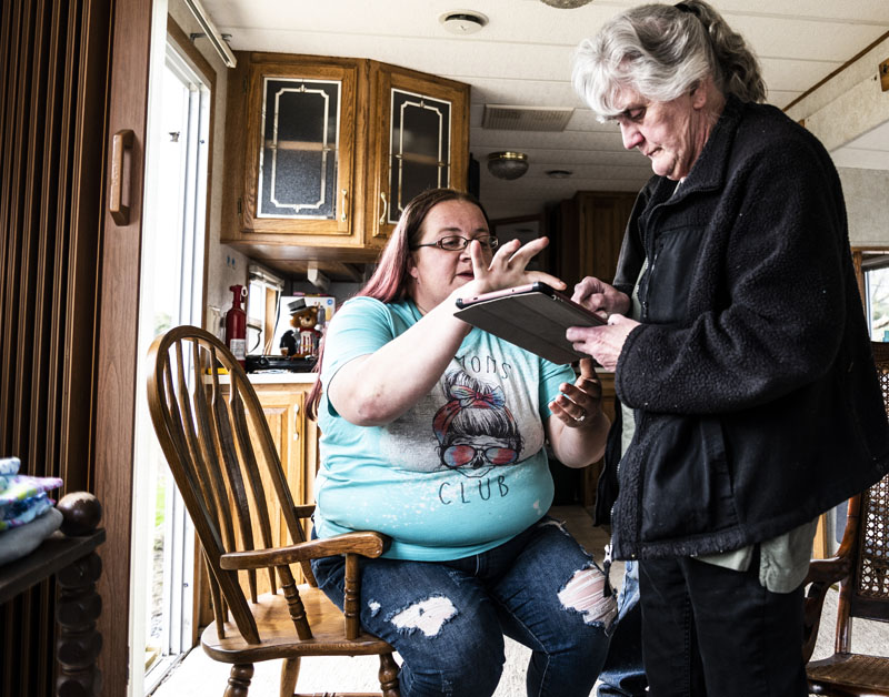 Rachel Lane helps her mother-in-law, Viola Stone, sign documents with her tablet in Waldoboro on May 4. Lane is helping Stone navigate the paperwok needed to bring a case in front of the town's appeals board. (Bisi Cameron Yee photo)