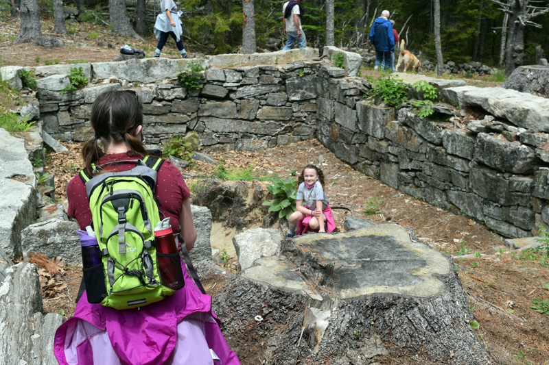 Shannon Taylor (left) photographs daughter Ori Taylor as she poses with a scavenger hunt item at the James Franklin Dunton home site in Westport Island on Sunday, May 23. (Nate Poole photo)