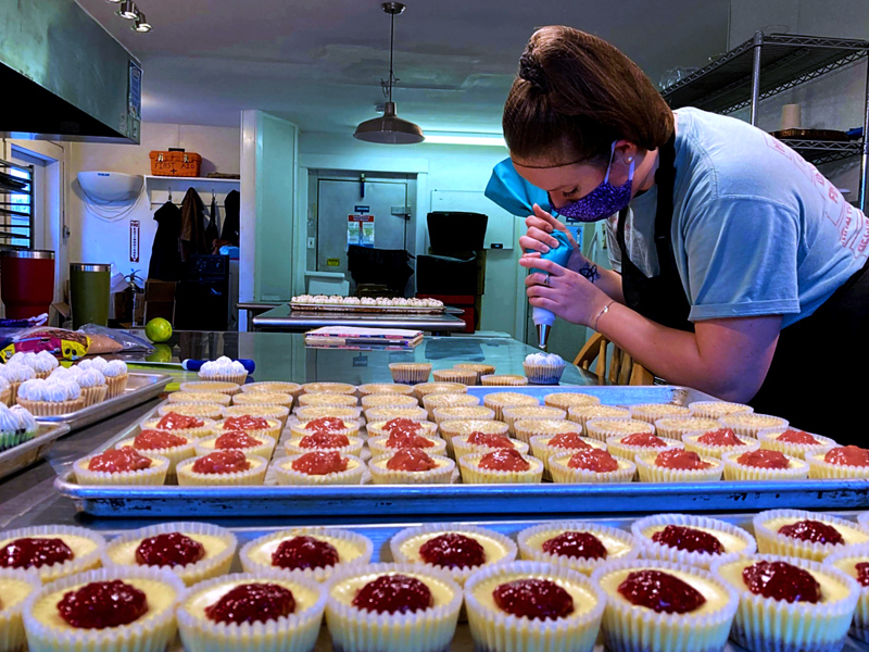 Emily St. Jarre prepares an order of miniature cheesecakes at Food Forge in Whitefield. (Nettie Hoagland photo)