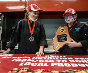 Whitefield Elementary School head cook Vicki Dill and eighth grader Kiara Luce show off their state championship plaque in Whitefield on Friday, May 7. (Bisi Cameron Yee photo)
