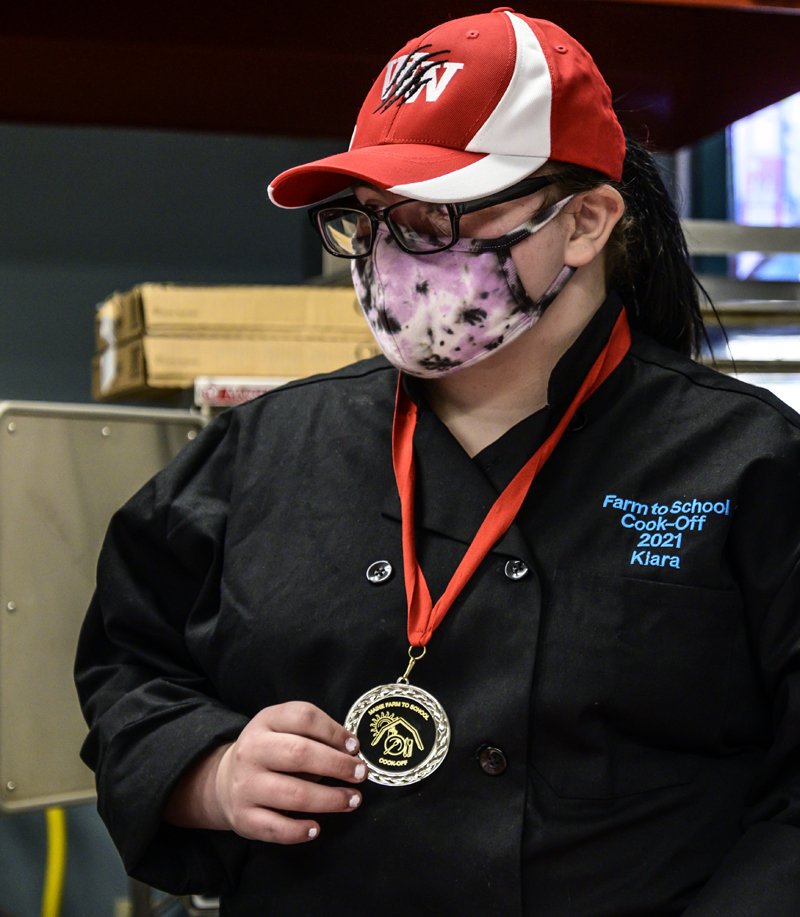 Kiara Luce displays her Farm to School Cook-off medal in Whitefield on Friday, May 7. Luce was the student half of Whitefield's state championship team. (Bisi Cameron Yee photo)
