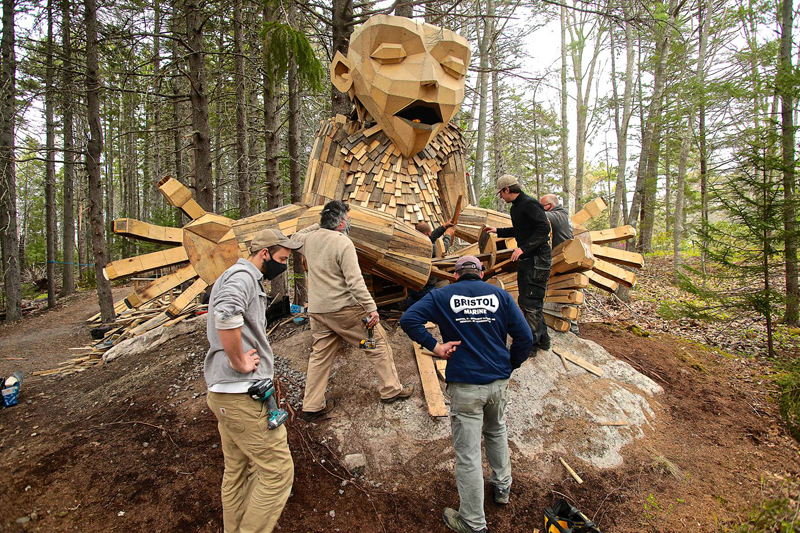 A crew from Bristol Marine assists with the installation of a giant troll at Coastal Maine Botanical Gardens.