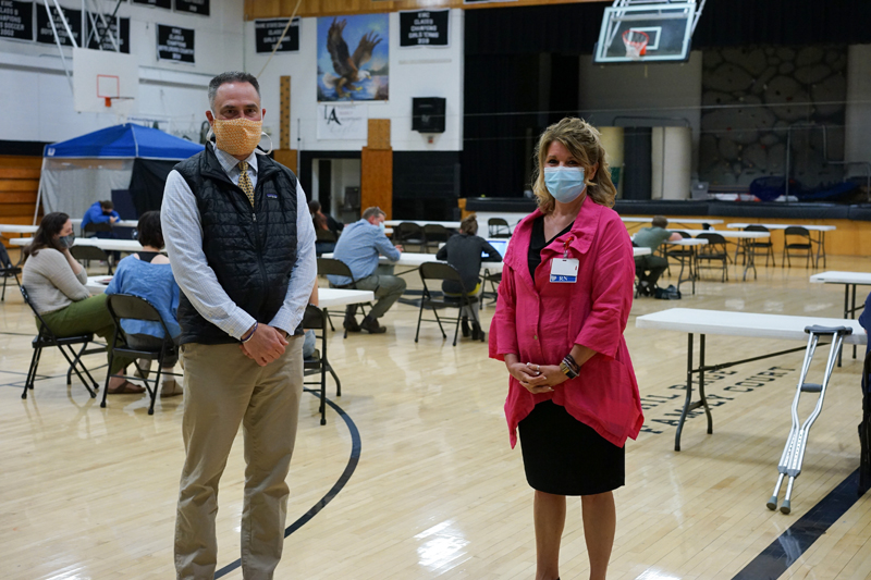 Lincoln Academy Head of School Jeff Burroughs (left) and LincolnHealth President Cindy Wade at the vaccination clinic at Lincoln Academy on Tuesday, May 18. The clinic gave 134 vaccinations on its first day.