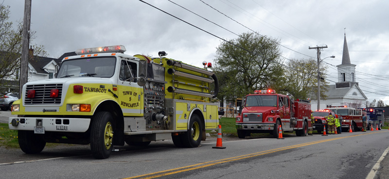 Fire trucks from Newcastle, Bremen, and Damariscotta, with an ambulance from the Central Lincoln County Ambulance Service, line Route 32 in Round Pond the afternoon of Friday, April 30. The display honored Bristol Fire Chief Paul Leeman Jr. on his last day as chief. (Maia Zewert photo)