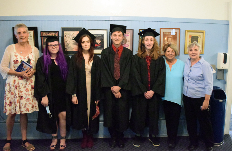 Central Lincoln County Adult Education graduates and instructors stand in the lobby of the Lincoln Theater before the graduation ceremony on Tuesday, June 8. From left: instructor Elizabeth Potter, Emmalie Blanchard, Honora Boothby, Zachary Baker, Norbert Ferrero, CLC Adult Education Director Pam Sperry, and instructor Bonnie Merrill. (Evan Houk photo)