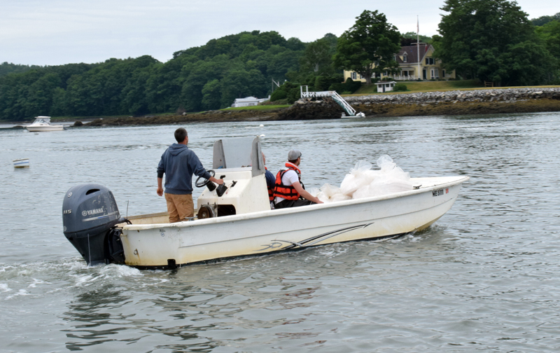 Newcastle firefighters cast off from the Damariscotta town landing to contain a diesel fuel spill in the Damariscotta River in Newcastle on the morning of Friday, June 25. The spill was located about 100 feet from a Norumbega Oyster, Inc. farm. (Evan Houk photo)