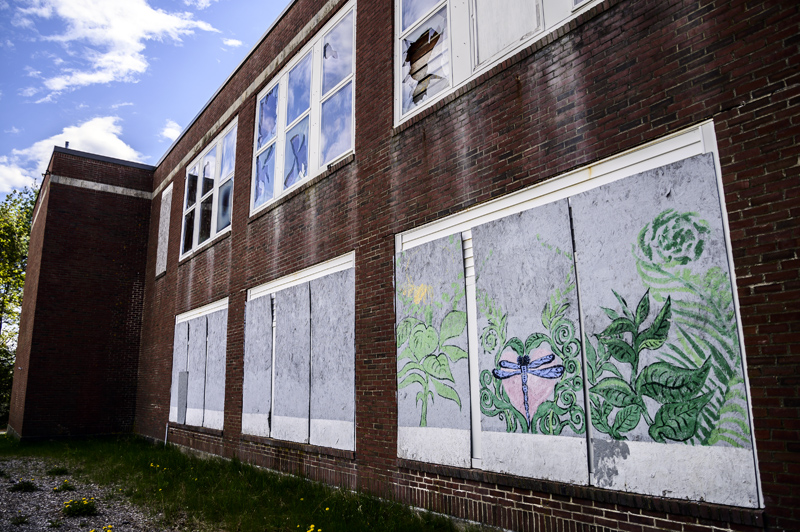 Graffiti covers boarded-up windows of the former A.D. Gray School in Waldoboro on May 14. Voters may decide the building's fate Tuesday, June 8. (Bisi Cameron Yee photo)