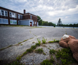 An abandoned teddy bear lay in the parking lot behind the A.D. Gray School in Waldoboro on Tuesday, June 8. Voters backed the plan by Volunteers of America to convert the building into affordable senior housing during the annual town meeting by referendum on Tuesday, June 8. (Bisi Cameron Yee photo)