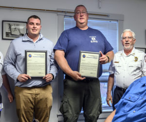 Waldoboro Emergency Medical Services Deputy Director Derek Booker (left) and EMS director Richard Lash (right) honored Emergency Medical Technicians Kobe Lincoln and Justin Hills with citations for their service to a resident in cardiac arrest in Waldoboro on Tuesday, June 22. (Bisi Cameron Yee photo)