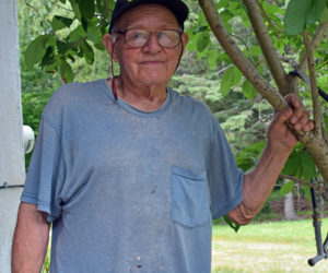 Herman Lovejoy stands outside of his home in Alna on Wednesday, July 7. Lovejoy has had several close brushes with death during his long career, beginning when he was hospitalized with polio at the age of 8. (Evan Houk photo)