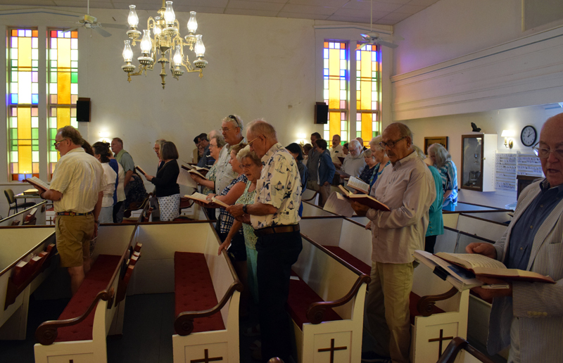 Churchgoers sing a hymn during the final service at the Round Pond United Methodist Church on Sunday, June 27. The 168-year-old building will now be transferred to the New England Conference of the United Methodist Church. (Evan Houk photo)