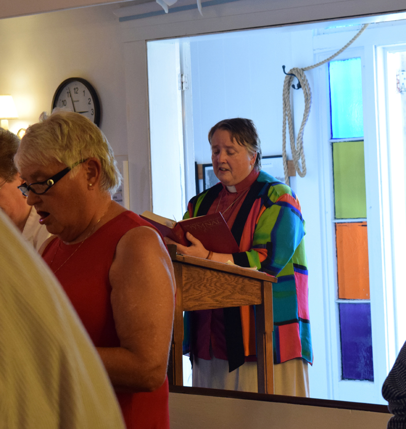 Pastor Kelly Harvell sings the final recessional hymn at the final service of the Round Pond United Methodist Church on Sunday, June 27. Approximately 43 people gathered to celebrate the life of the church and reflect on its 168-year history. (Evan Houk photo)