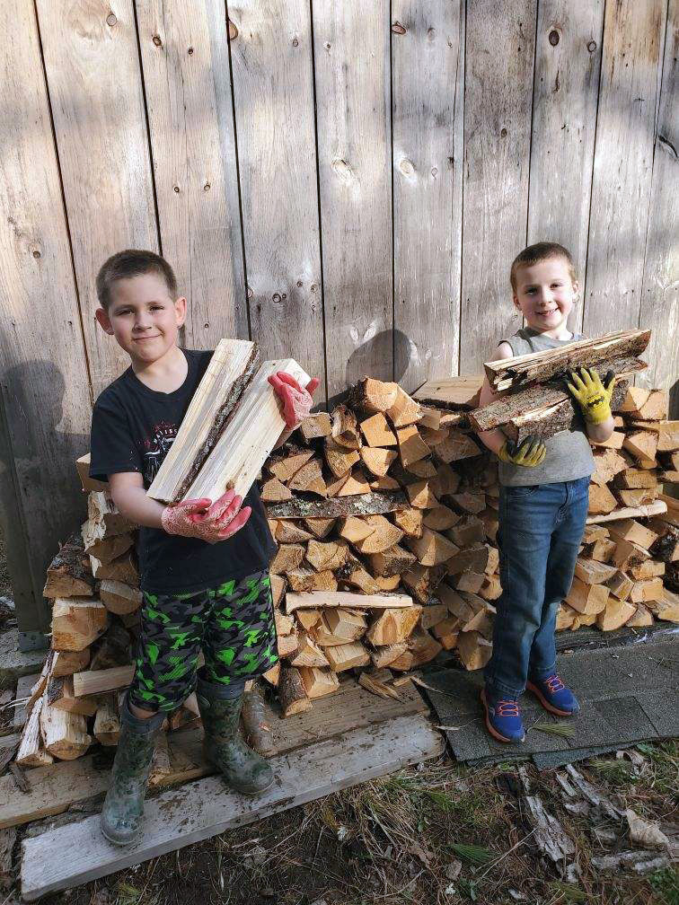 Best friends Zachary Hoppe (left) and Ryan Parson (right), both 7, recently started a new business selling camp firewood at 77 Biscay Road in Damariscotta. (Photo courtesy Jessica Hoppe)