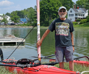 Michael "Mike" Herz stands by his trimaran sailing vessel at his home on the Damariscotta River on Tuesday, July 27. Herz has sailed all over the world and continues to sail and stand-up paddleboard in the river. (Evan Houk photo)
