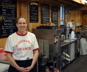 Mary Blanchard stands in Blanchard's Creamery, the ice cream and coffee shop she opened in Edgecomb over Memorial Day weekend. With free Wi-Fi and a cozy barn interior, Blanchard wants her business to be a summer hub in Edgecomb. (Nate Poole photo)