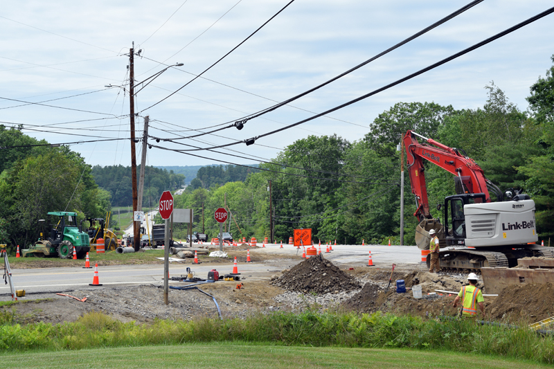 A construction crew works on the Maine Department of Transportation project at the intersection of Route 1 and Route 27 on Tuesday, July 13. The project involves installing a protected lane and islands at the intersection to allow easier access for traffic merging. (Nate Poole photo)
