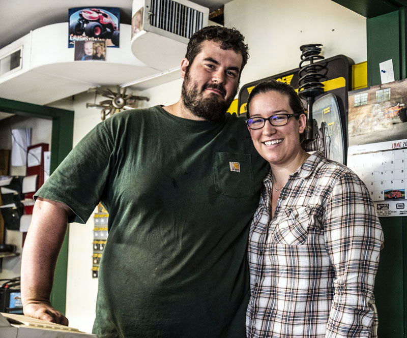 Steven and Kendra Reynolds stand behind the counter of All Seasons Automotive in Jefferson on Friday, June 25. Steven Reynolds is leaving the shop for a position with Bath Iron Works in Bath. (Bisi Cameron Yee photo)