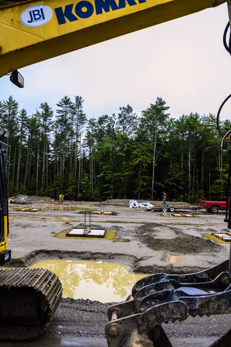 Workers prepare the ground for continuing construction on an aquaculture facility after a rainy morning in Waldoboro on July 19. The site was initially approved in early 2019, but construction was delayed due to COVID-19. (Bisi Cameron Yee photo)
