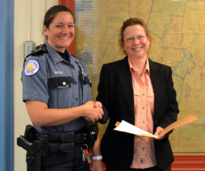 Communications Director Tara Doe presents the Maine EMS for Children Stork Award to Lincoln County Dispatcher Jennifer Gosselin during the Lincoln County Board of Commissioners meeting on Tuesday, July 20. (Charlotte Boynton photo)