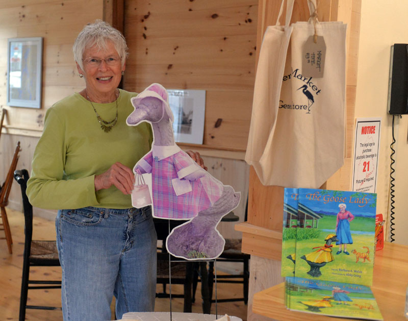 Jefferson summer resident Sally Kinkade holds up a picture of the concrete goose that belong to her mother Marjorie Bean Scott. Scott and the goose are the subject of a new children's book "The Goose Lady," by Barbara A. Walsh. (Paula Roberts photo)