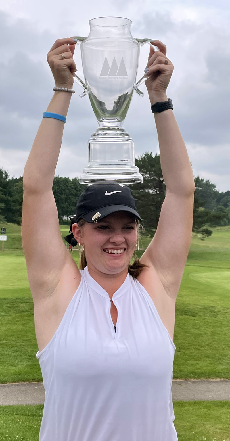 Bailey Plourde hoists her Maine Women's Amateur Golf Tournament's first place trophy over head in celebration. (Photo courtesy Lynne Plourde)