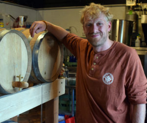 Chauncey Erskine, owner of Maine Booch, stands by a bourbon barrel from Split Rock Distilling used to ferment his kombucha and make it alcoholic on Monday, Aug. 2. Maine Booch will be opening a tasting room at 85 Parking Lot Lane in the Damariscotta municipal parking lot from 5-9 p.m. on Monday, Aug. 9. (Evan Houk photo)