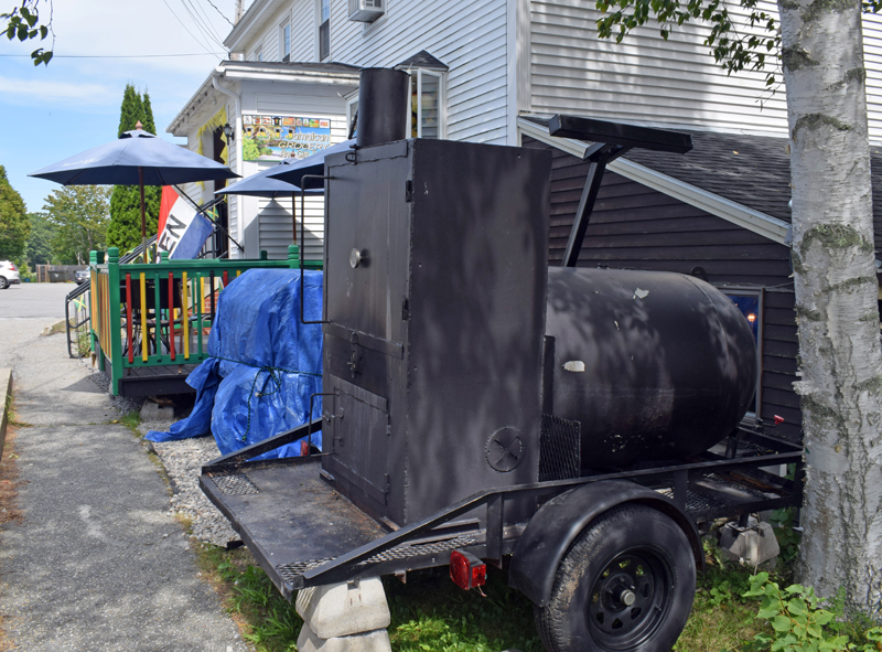 A food smoker sits in front of J & J Jamaican Grocery and Gift Shop at 88 Main Street in Damariscotta on Tuesday, Aug. 3. The town's Code Enforcement Officer issued a cease-and-desist letter for the smoker operations on Sunday, Aug. 1 after receiving complaints on Saturday, July 31. (Evan Houk photo)