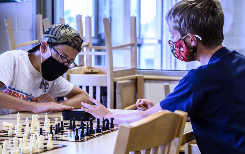 Trevor Hall , 12, (left) and Cooper Powell, 11, play a timed match during a chess club meeting in Jefferson on Tuesday, Aug. 3. The two engaged in a playful "super speed round" with only 30 seconds on the clock. (Bisi Cameron Yee photo)