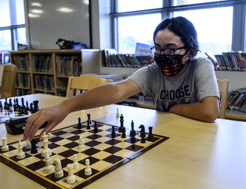 Shayla Pheng, 11, threatens the opposition's king during a chess club meeting in Jefferson on Tuesday, Aug. 3. Pheng has been playing for eight months and has a 1,200 rating at chess.com (Bisi Cameron Yee photo)