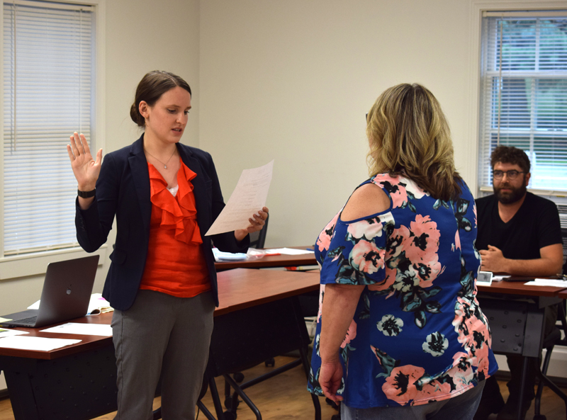 Newcastle Town Manager Sarah Macy is sworn in by Town Clerk and Interim Town Manager Michelle Cameron as Joel Lind, chair of the Newcastle Board of Selectmen, looks on on Monday, Aug. 9. Macy, who previously was executive assistant to the city manager, mayor, and city solictor in Waterville, is Newcastle's second town manager. (Evan Houk photo)