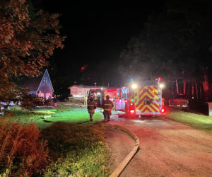 Fire fighters approach the scene of a house fire on Hilton Road in Whitefield, on Friday, Aug. 13. (Raye Leonard photo)