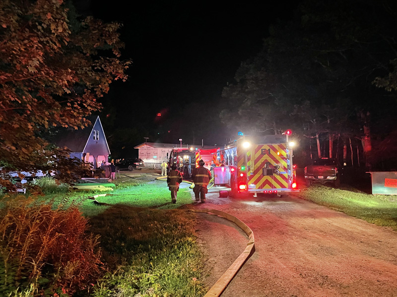 Fire fighters approach the scene of a house fire on Hilton Road in Whitefield, on Friday, Aug. 13. (Raye Leonard photo)