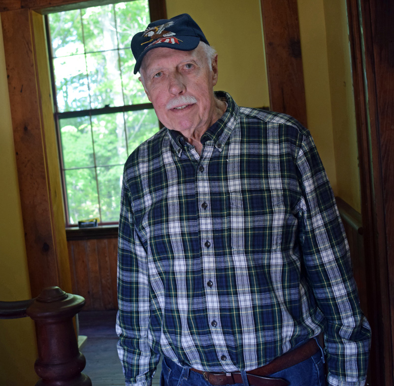 Bill Smith stands in the entryway of the restored Washington School in Round Pond. Smith, who attended the school from 1938 to 1946, helped found the nonprofit Round Pond Schoolhouse Association that worked to restore the 1885 building before it was to be burned as a training exercise for the fire department. (Evan Houk photo)