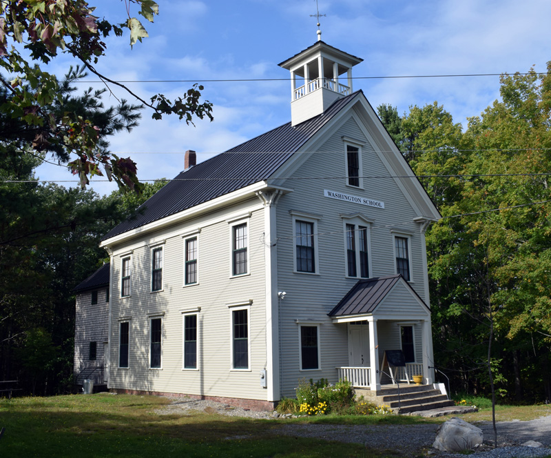 The 1885 Washington School building in Round Pond has been restored as a museum with old school desks and books. Bill Smith, a board member of the nonprofit Round Pond Schoolhouse Association, said that the Village Improvement Society recently sold the driveway to the school to the nonprofit. (Evan Houk photo)
