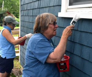 Stepping Stone Housing, Inc. President Marilee Harris and board member Carolyn Neighoff paint a house at Blue Haven, a neighborhood in Damariscotta where the nonprofit owns six homes that are provided as affordable housing options, during Community Cares Day on Saturday, Sept. 11. (Evan Houk photo)