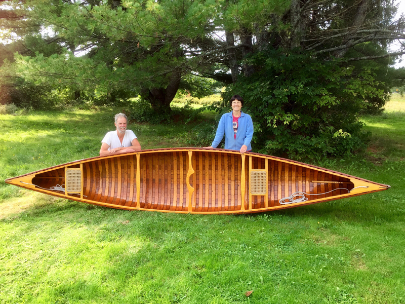 Zip Kellogg and BB Adams with a wooden canoe that they frequently paddle together. Kellogg, a retired librarian, and Adams, a teacher, are both serious paddlers, but met 11 years ago while out dancing. (Photo courtesy Zip Kellogg)