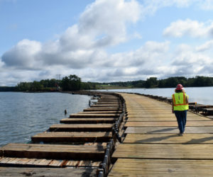 LCN editor Raye Leonard walks with Central Maine Power Co. Project Manager Nicole Harbaugh and CMP spokesperson Catherine Hartnett on the power company's "floating road" in Great Salt Bay in Newcastle on Friday, Sept. 10. The road was used to access an island for repairs and will be taken out this week. (Evan Houk photo)