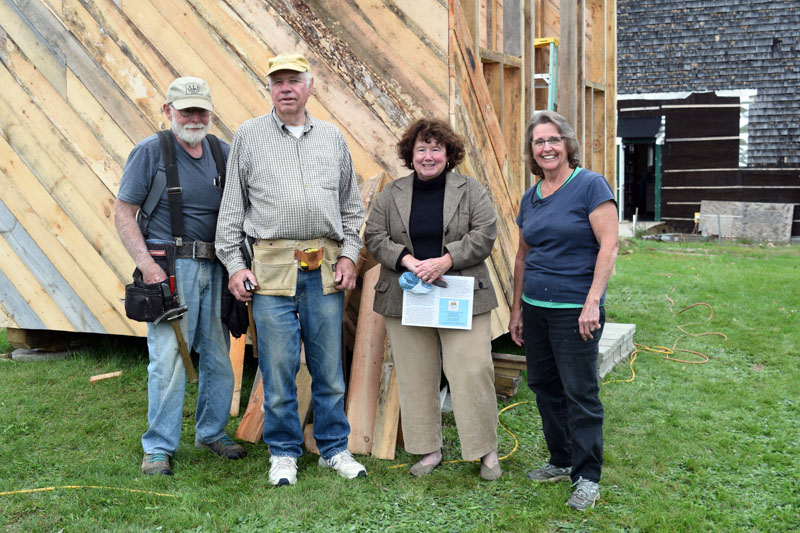 From left: Erik Ekholm, Dennis Merrill, Sue McKeen, and Cheryle Joslyn in front of the Whitefield Library and Community Center's in-progress storage shed on Sept. 28. (Nate Poole photo)