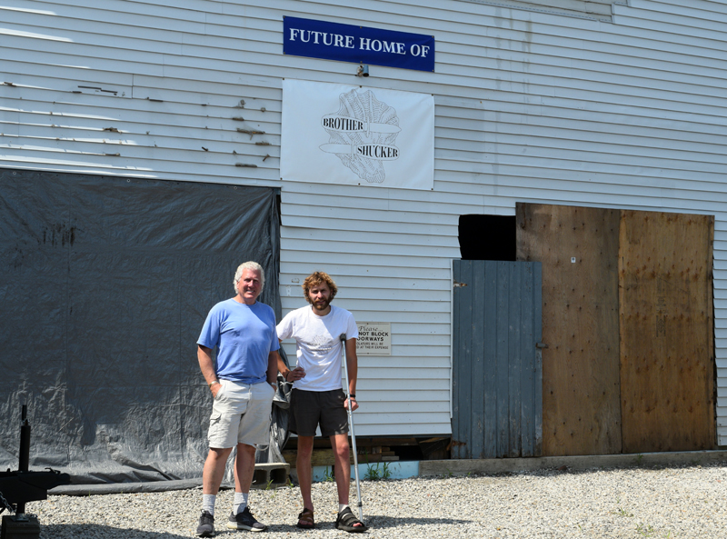 Zak Kuras and Craig Winslow in front of the raw bar's eventual homebase at 4 Railroad Avenue. Winslow and the Kuras brothers are hoping the have the restaurant up and running by early 2022. (Nate Poole photo)