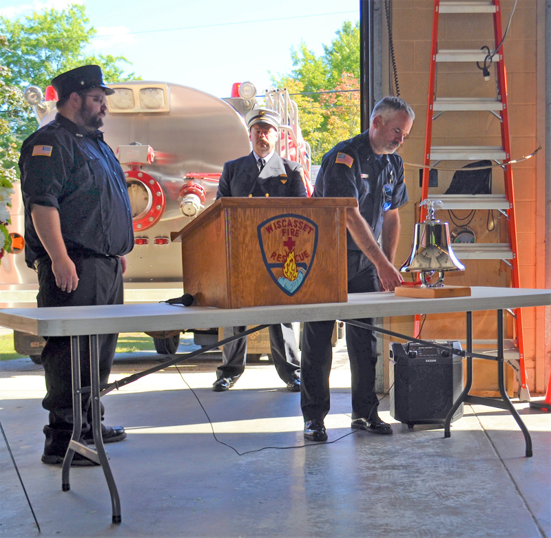 Wiscasset Fire Fighters Dan Averell, left and Matt Gordon conduct the bell ring ceremony. Wiscasset Fire Chief Ron Bickford observes the ceremony in the rear, at the Celebration of Life service for the late Peter Rines, Sunday, September 19, at Wiscasset Fire Station. (Charlotte Boynton photo)