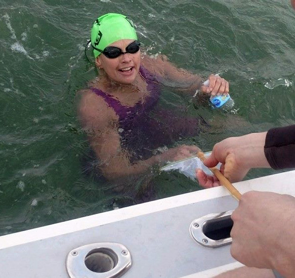 Alison Hayden rehydrates while swimming the length of the Damariscotta River. (photo provided by Alison Hayden)