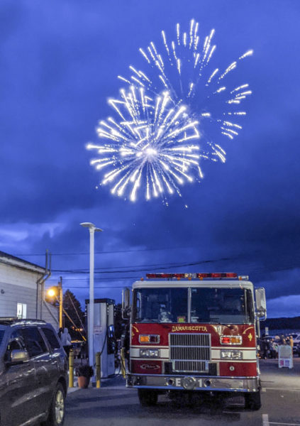 Vehicles from the Damariscotta Fire Department sit in the parking lot of the Colby & Gale Inc. service station in downtown Damariscotta during a fireworks display on July 4. (Nate Poole photo)